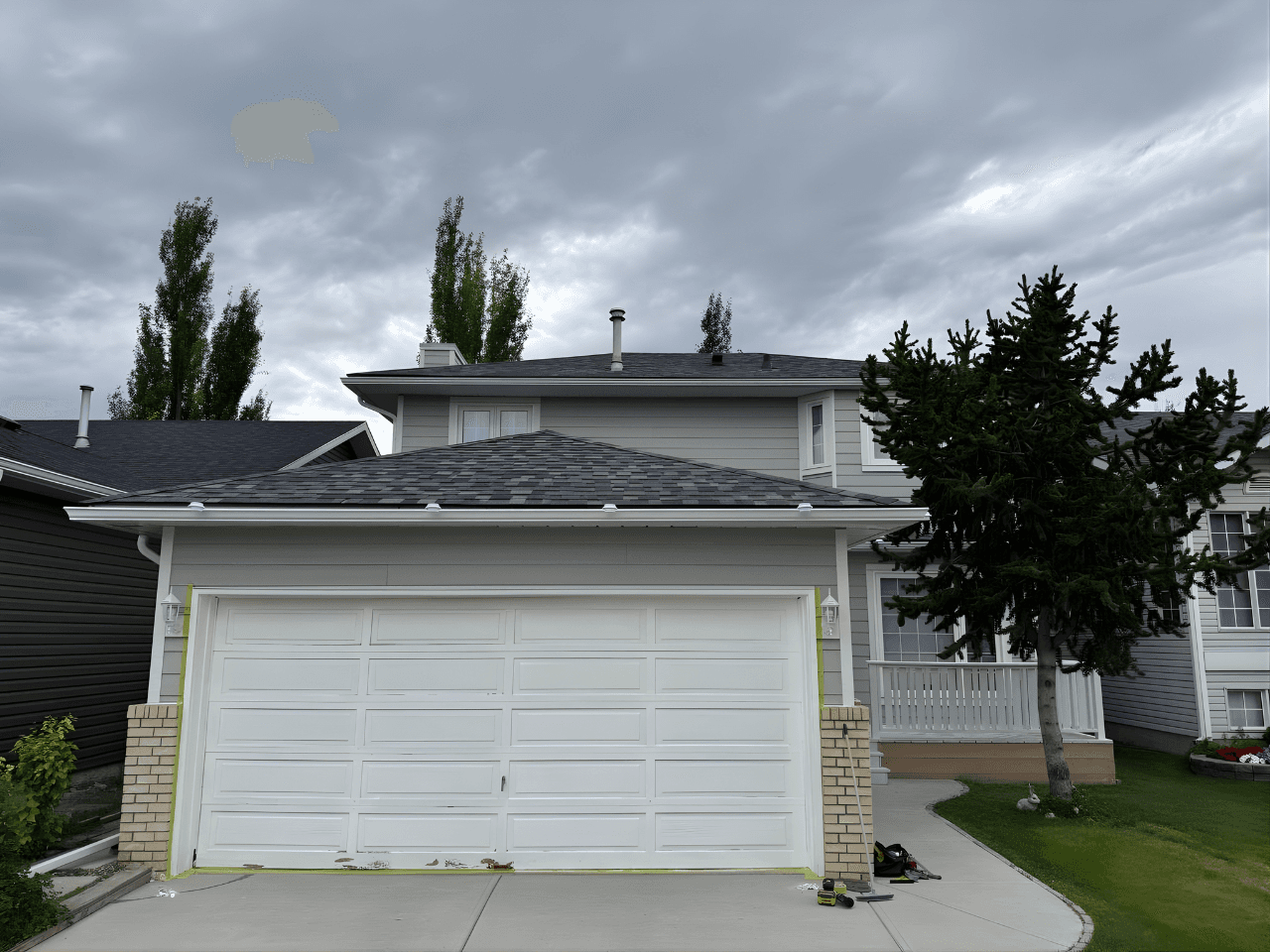 Exterior renovation combining James Hardie siding in Pearl Grey with LP SmartTrim in Arctic White. A balanced, modern color palette paired with durable materials for a sharp, long-lasting finish.